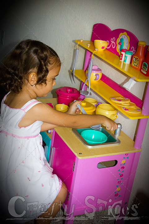 Kira playing with her new Kitchen