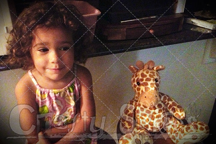 Kira and baby Giraffe sitting next to each other.