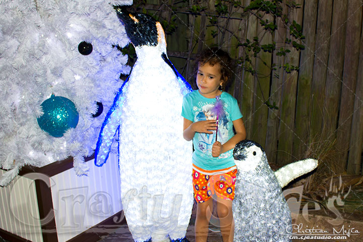 Kira with the lighted penguins at Busch Gardens Christmas town