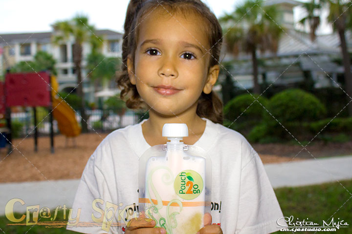 Kira holding a Pouch2Go with a berry-fruit mix